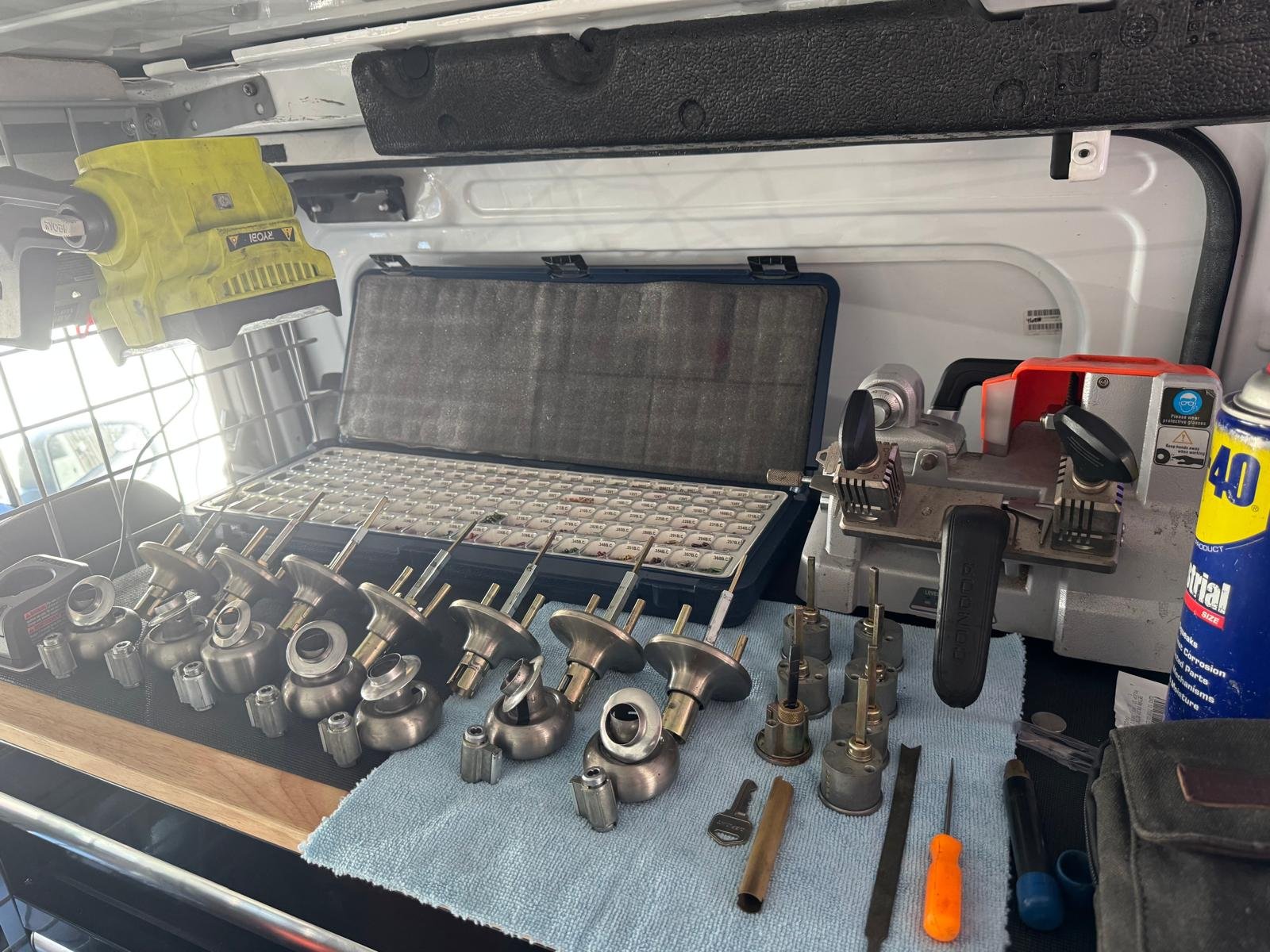 Commercial Locksmith in Tampa working from a service van with professional lock rekeying equipment, door hardware, and key cutting tools.